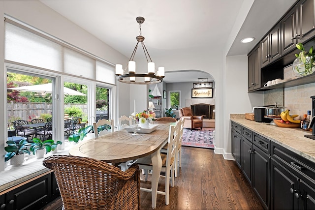 2951 Colfax St, Evanston, IL 60201 - dining room featuring a chandelier, dark wood-style flooring, arched walkways, and recessed lighting