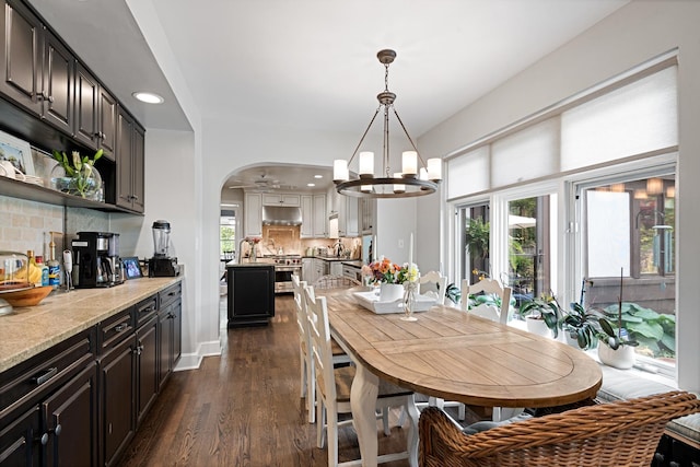 2951 Colfax St, Evanston, IL 60201 - dining space featuring a chandelier, dark wood-type flooring, recessed lighting, arched walkways, and a ceiling fan