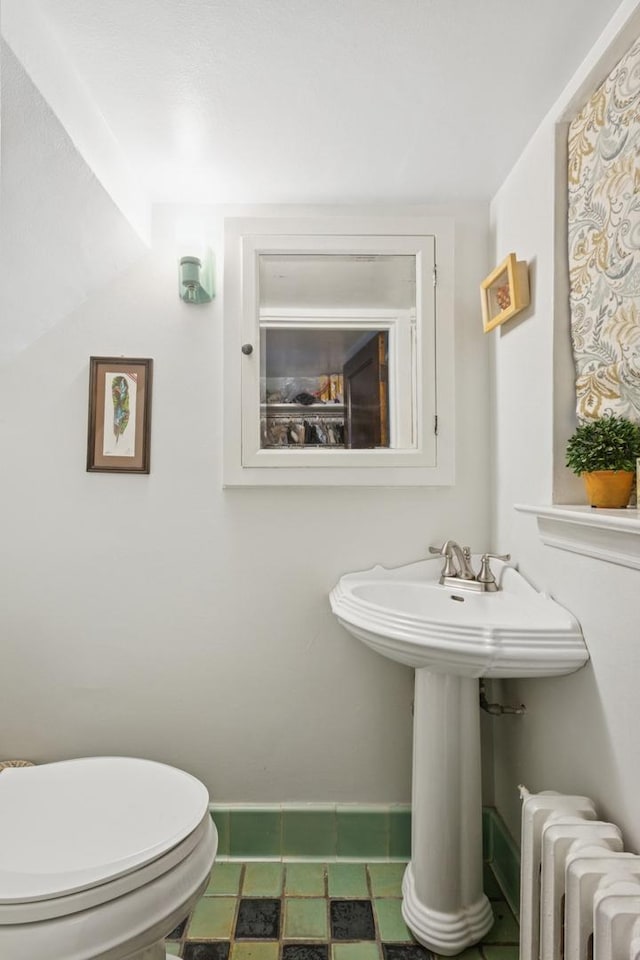 2951 Colfax St, Evanston, IL 60201 - bathroom featuring radiator, baseboards, toilet, and a sink