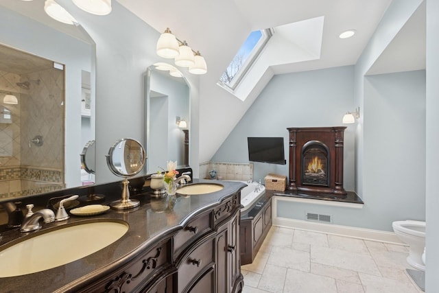 2951 Colfax St, Evanston, IL 60201 - full bathroom with a skylight, toilet, double vanity, a tile shower, and vaulted ceiling