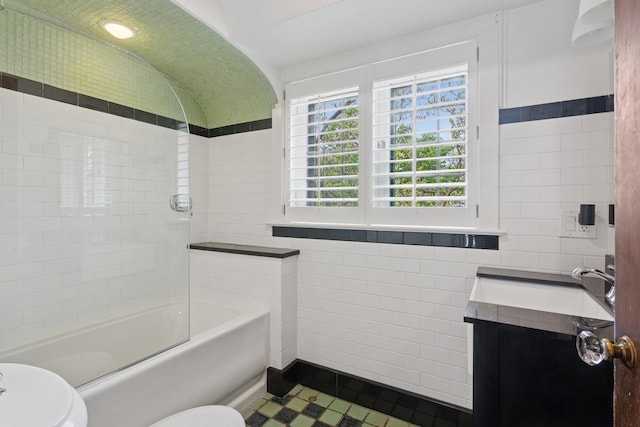 2951 Colfax St, Evanston, IL 60201 - full bathroom featuring tile walls, toilet, vanity, tile patterned flooring, and  shower combination