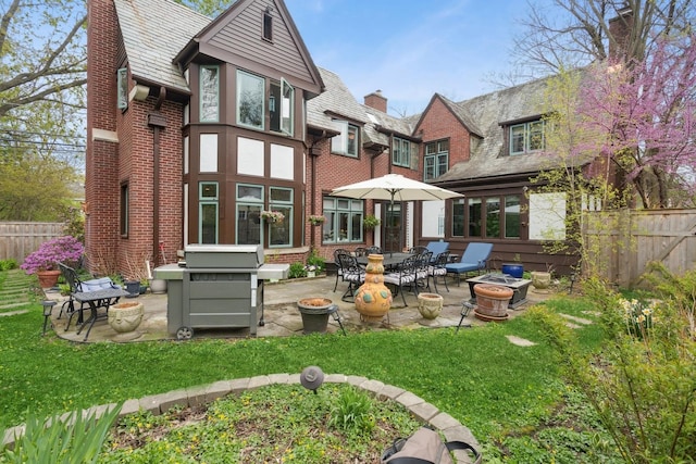 2951 Colfax St, Evanston, IL 60201 - rear view of property featuring a patio area, a high end roof, a chimney, and brick siding
