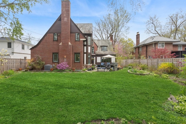 2951 Colfax St, Evanston, IL 60201 - back of house featuring brick siding, a chimney, cooling unit, and a patio