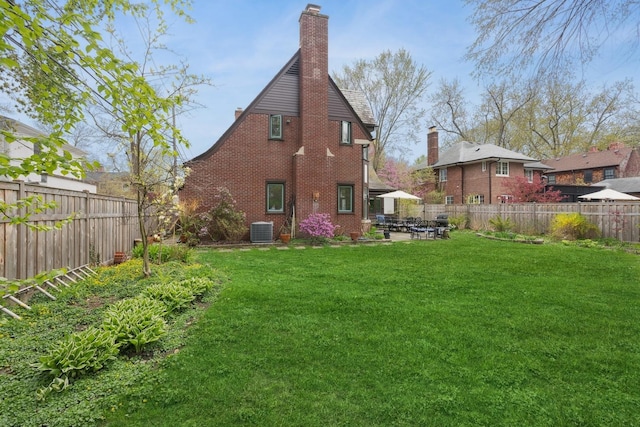 2951 Colfax St, Evanston, IL 60201 - rear view of house featuring a chimney, cooling unit, a patio area, and brick siding