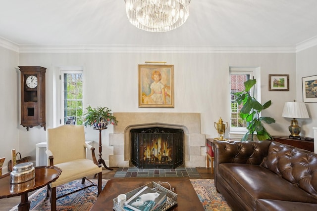 2951 Colfax St, Evanston, IL 60201 - living room featuring ornamental molding, a tiled fireplace, and a chandelier