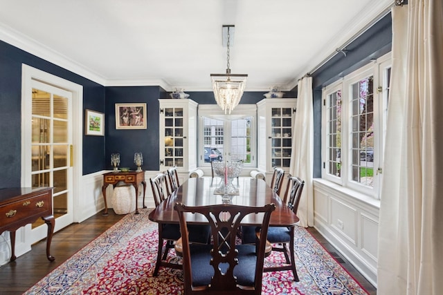2951 Colfax St, Evanston, IL 60201 - dining area featuring dark wood-style flooring, crown molding, a decorative wall, a wainscoted wall, and a chandelier