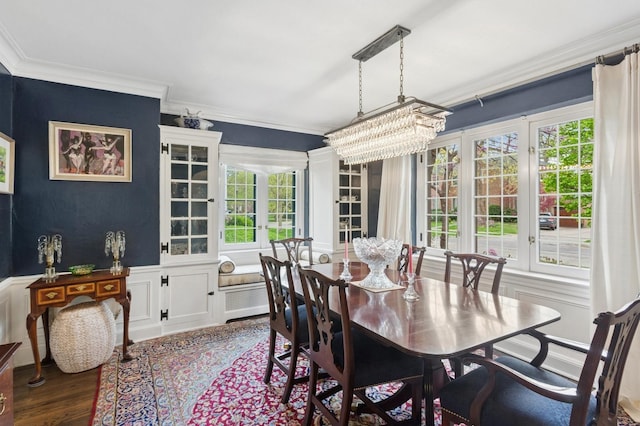 2951 Colfax St, Evanston, IL 60201 - dining room featuring ornamental molding, a chandelier, plenty of natural light, wood finished floors, and wainscoting