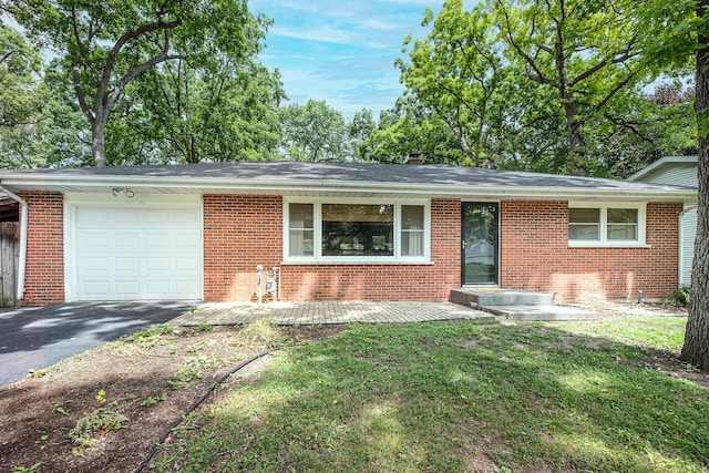 308 Dunbar Rd, Mundelein, IL 60060 - view of front facade featuring a garage, brick siding, asphalt driveway, and a front yard