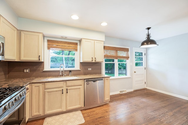 308 Dunbar Rd, Mundelein, IL 60060 - kitchen with appliances with stainless steel finishes, healthy amount of natural light, light wood-style flooring, tasteful backsplash, and recessed lighting