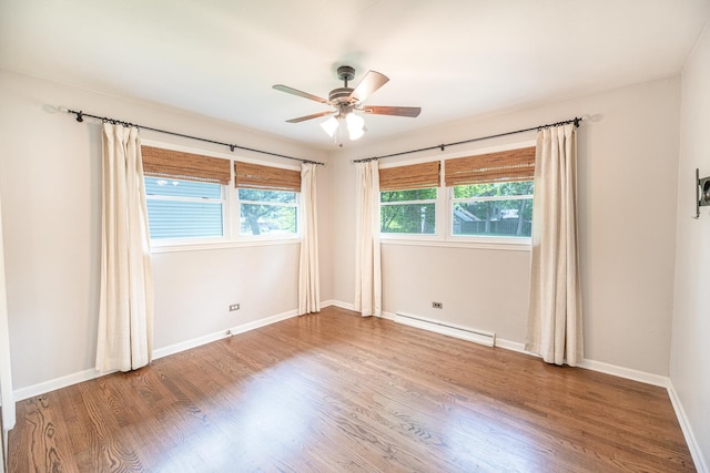 308 Dunbar Rd, Mundelein, IL 60060 - empty room with a baseboard heating unit, a ceiling fan, and wood finished floors