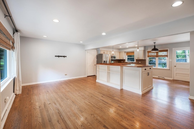 308 Dunbar Rd, Mundelein, IL 60060 - kitchen featuring appliances with stainless steel finishes, light wood finished floors, recessed lighting, decorative light fixtures, and a center island