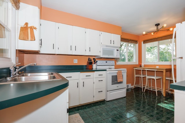 103 N Adelaide St, Normal, IL 61761 - kitchen featuring white appliances, white cabinets, and dark countertops