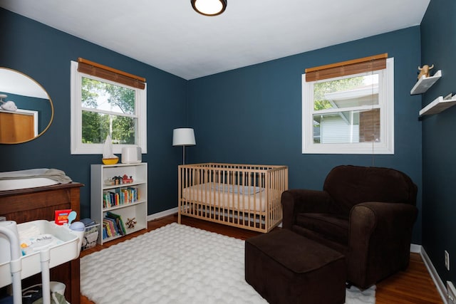 103 N Adelaide St, Normal, IL 61761 - bedroom featuring wood finished floors and a crib