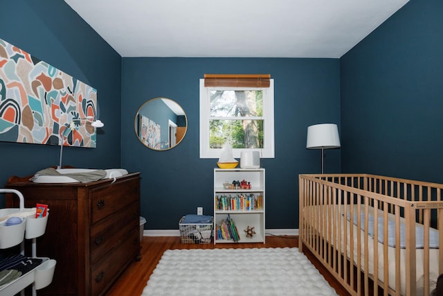 103 N Adelaide St, Normal, IL 61761 - bedroom featuring wood finished floors and a nursery area