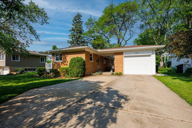 103 N Adelaide St, Normal, IL 61761 - view of front of home with concrete driveway, a garage, a front yard, and brick siding