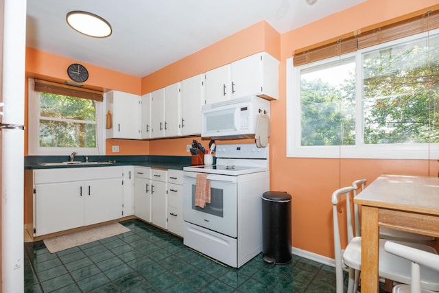 103 N Adelaide St, Normal, IL 61761 - kitchen featuring white appliances, dark countertops, white cabinets, and dark floors