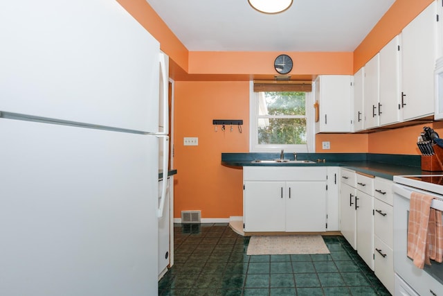 103 N Adelaide St, Normal, IL 61761 - kitchen with white appliances, dark countertops, white cabinetry, and dark tile patterned flooring