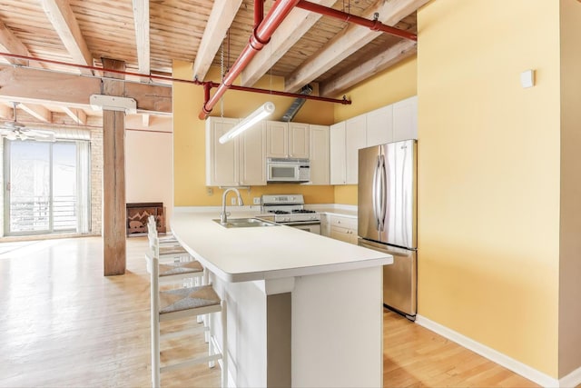 7240 Franklin St Unit 2A, Forest Park, IL 60130 - kitchen with white appliances, light wood finished floors, a wood ceiling with exposed beams, light countertops, and a peninsula