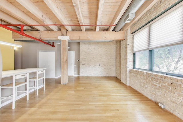 7240 Franklin St Unit 2A, Forest Park, IL 60130 - empty room featuring beam ceiling, wood finished floors, and brick wall