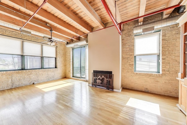 7240 Franklin St Unit 2A, Forest Park, IL 60130 - unfurnished living room featuring healthy amount of natural light, wood finished floors, a wooden ceiling with exposed beams, a ceiling fan, and brick wall