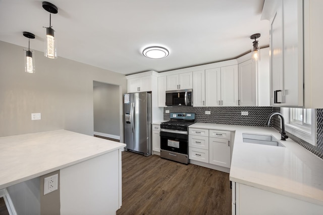 403 Wilshire St, Park Forest, IL 60466 - kitchen featuring appliances with stainless steel finishes, decorative backsplash, dark wood finished floors, white cabinets, and decorative light fixtures