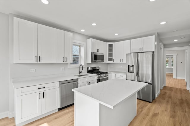 2445 Highland Ave, Berwyn, IL 60402 - kitchen with appliances with stainless steel finishes, white cabinetry, recessed lighting, glass insert cabinets, and light wood-style floors