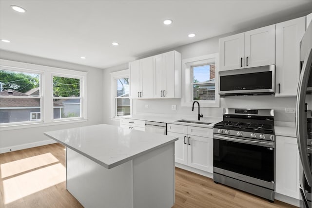 2445 Highland Ave, Berwyn, IL 60402 - kitchen featuring stainless steel appliances, plenty of natural light, white cabinetry, light wood-type flooring, and recessed lighting