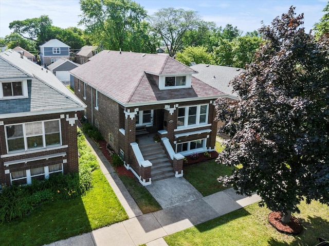 2445 Highland Ave, Berwyn, IL 60402 - view of front facade featuring brick siding, a front yard, covered porch, and stairs