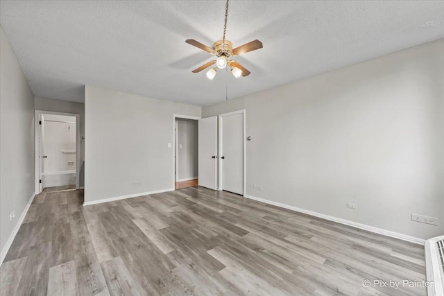 2000 Saint Regis Dr Unit 1D, Lombard, IL 60148 - unfurnished bedroom featuring a textured ceiling, wood finished floors, and ceiling fan