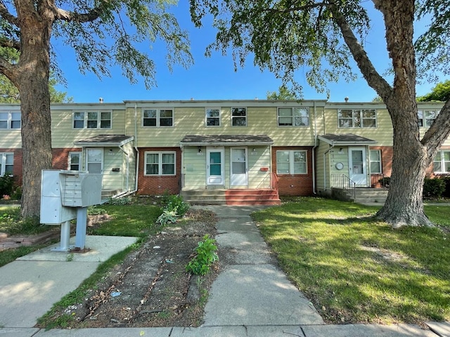 1106 Saint Andrews Cir Unit 1, Rantoul, IL 61866 - townhome / multi-family property featuring brick siding and a front yard
