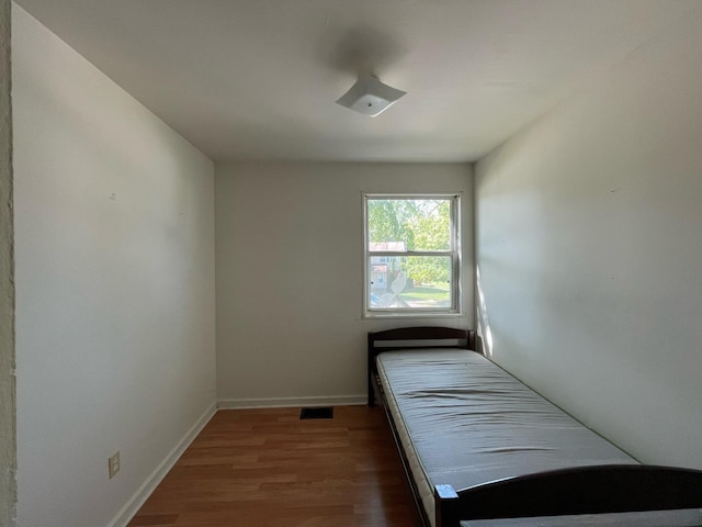 1106 Saint Andrews Cir Unit 1, Rantoul, IL 61866 - unfurnished bedroom with wood finished floors and baseboards