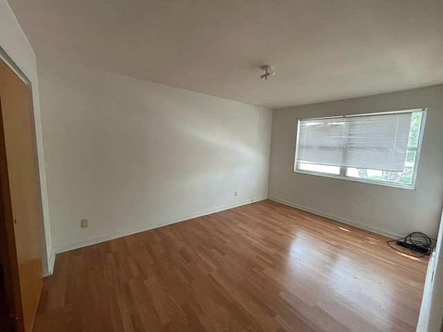 1106 Saint Andrews Cir Unit 1, Rantoul, IL 61866 - spare room with wood finished floors and baseboards
