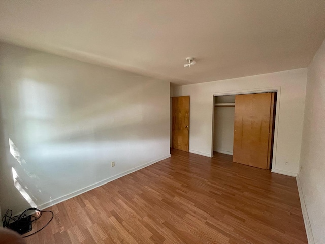 1106 Saint Andrews Cir Unit 1, Rantoul, IL 61866 - unfurnished bedroom with wood finished floors and a closet