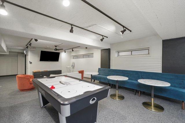 4950 N Marine Dr Unit 1105, Chicago, IL 60640 - recreation room featuring track lighting, a textured ceiling, and speckle patterned floor