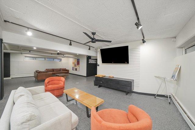 4950 N Marine Dr Unit 1105, Chicago, IL 60640 - living room with a baseboard radiator, rail lighting, a ceiling fan, and a textured ceiling