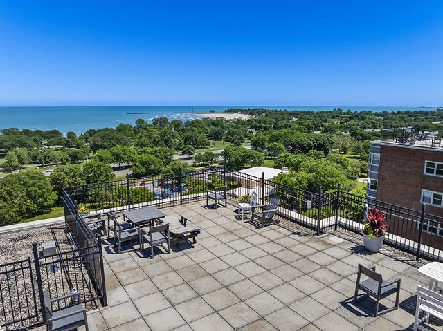4950 N Marine Dr Unit 1105, Chicago, IL 60640 - view of patio featuring a water view and view of wooded area
