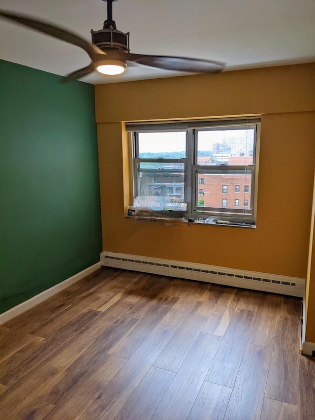 4950 N Marine Dr Unit 1105, Chicago, IL 60640 - spare room with a ceiling fan, a baseboard heating unit, and dark wood-type flooring