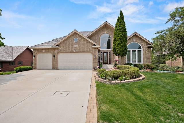 1542 Woodcreek Trl, Bartlett, IL 60103 - view of front facade with brick siding, an attached garage, concrete driveway, and a front lawn
