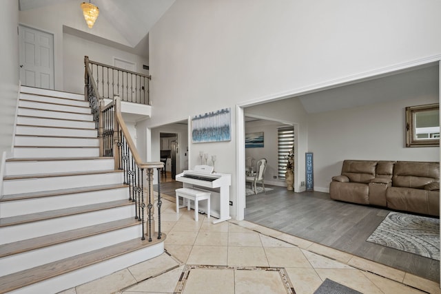 1542 Woodcreek Trl, Bartlett, IL 60103 - staircase with tile patterned floors, high vaulted ceiling, and inlaid floor details