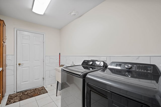 1542 Woodcreek Trl, Bartlett, IL 60103 - washroom featuring washing machine and dryer, tile walls, wainscoting, and light tile patterned flooring