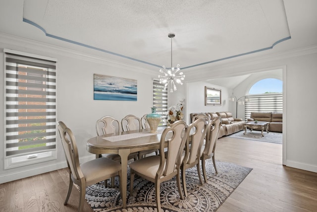 1542 Woodcreek Trl, Bartlett, IL 60103 - dining space with a textured ceiling, wood finished floors, crown molding, and a chandelier