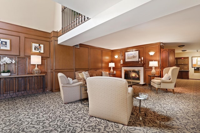 1105 N Mill St Unit 215, Naperville, IL 60563 - living area with a decorative wall, a glass covered fireplace, carpet floors, and a towering ceiling