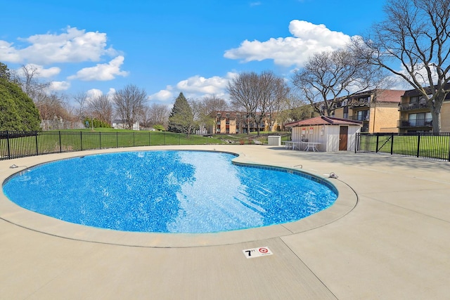 1105 N Mill St Unit 215, Naperville, IL 60563 - community pool featuring a patio area and an outbuilding