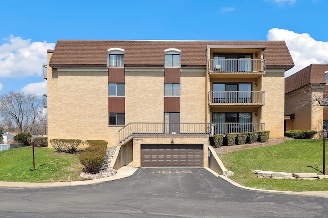 1105 N Mill St Unit 215, Naperville, IL 60563 - view of apartment building / complex with an attached garage and driveway