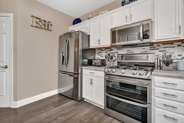 6743 S Pointe Dr Unit 1C, Tinley Park, IL 60477 - kitchen with appliances with stainless steel finishes, tasteful backsplash, light countertops, white cabinets, and dark wood-style flooring
