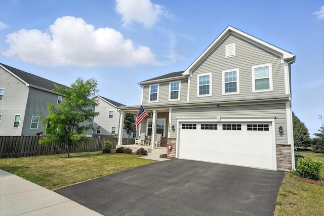 2632 Pecos Cir, Montgomery, IL 60538 - traditional-style home with asphalt driveway, stone siding, covered porch, and a garage