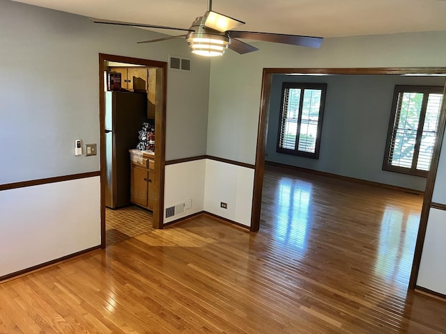 3485 Ronald Rd, Crete, IL 60417 - unfurnished room featuring ceiling fan, light wood-style floors, and healthy amount of natural light
