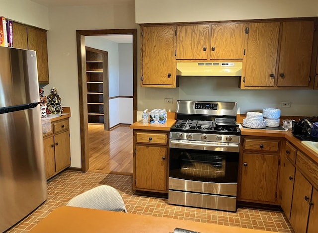 3485 Ronald Rd, Crete, IL 60417 - kitchen with stainless steel appliances, under cabinet range hood, and brown cabinetry
