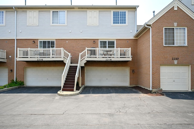 2208 W Concord Ln, Addison, IL 60101 - back of property featuring a garage, asphalt driveway, and brick siding