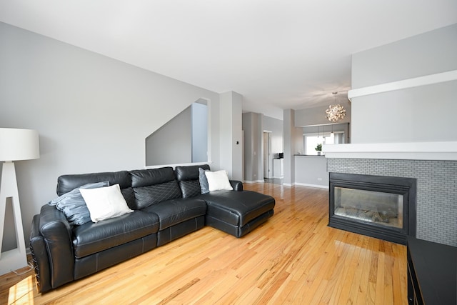 2208 W Concord Ln, Addison, IL 60101 - living room featuring a chandelier, hardwood / wood-style flooring, and a tiled fireplace
